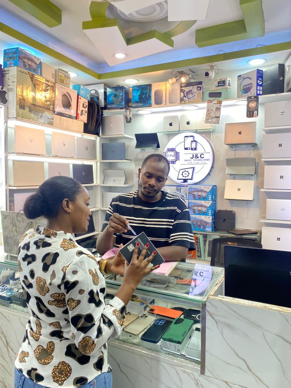 A customer purchasing an electronic device at our Kampala retail outlet.